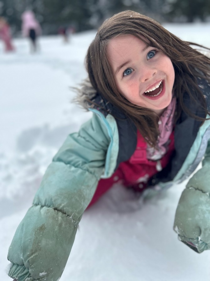 A child in the snow
Description automatically generated