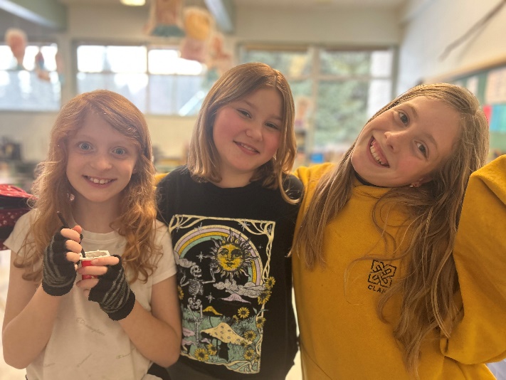 A group of girls smiling for a picture
Description automatically generated