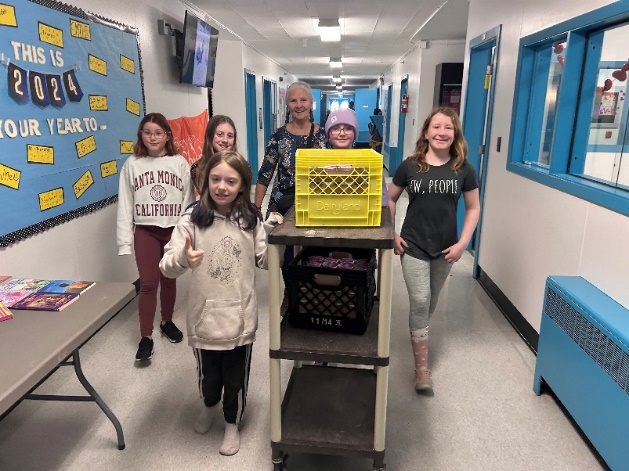 A group of kids standing in a hallway
Description automatically generated