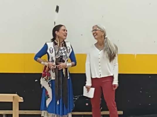 Two women standing in a room
Description automatically generated