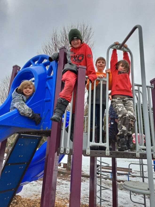 A group of kids on a playground
Description automatically generated