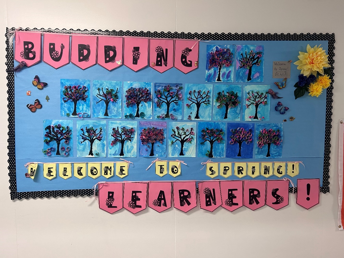 A bulletin board with art on it
Description automatically generated