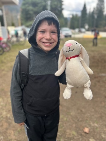 A child holding a stuffed animal
Description automatically generated