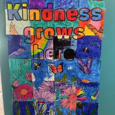 A colourful hand-drawn poster that reads, "kindness grows here."