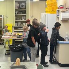 Elementary school students in a school kitchen preparing food