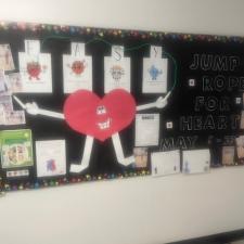Drawings tacked to on a bulletin board in a school.