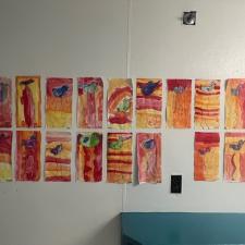 Orange, yellow and red designs adorn a school hallway.