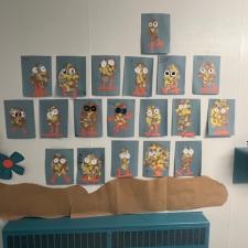 Multiple drawings of monsters attached to a school hallway in an elementary school. 