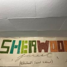 A poster that says, Sherwood Forest in multicolour block letters.