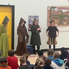 Elementary students dressed as Robin hood and characters from the tale.