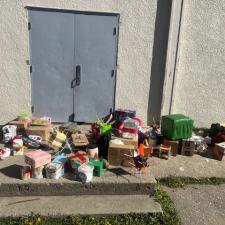 Colourful boxes and contraptions in front of a school gymnasium outside in the sunshine