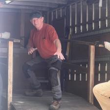 A construction worker poses in a cargo truck